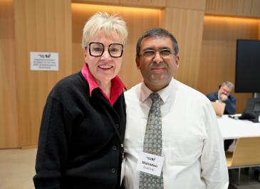 Attendees posing and smiling directly at the camera