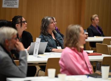 Attendees listening to and/or watching presenters
