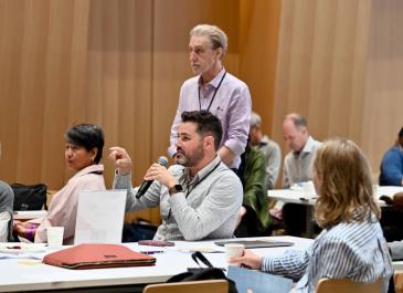 An attendee asking a question from the audiance