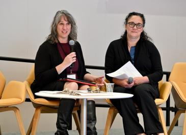 Joann Goode and Mary Beshai on stage speaking
