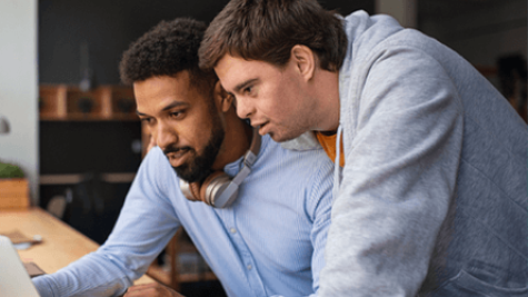 two colleagues looking at a computer together