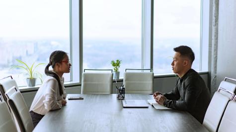 Man and woman sitting face to face across a table