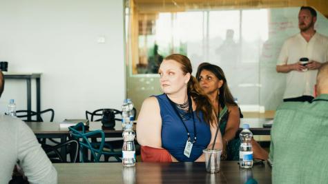 Three people at a table looking toward a presentation off screen