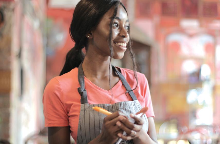Woman taking an order at a café