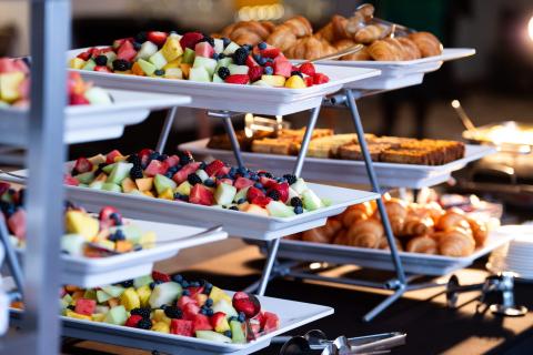 Fruits and pastries on display platters