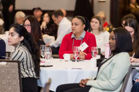 Five people at a table turned towards the speaker. 