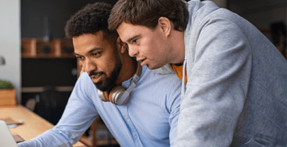 two colleagues looking at a computer together