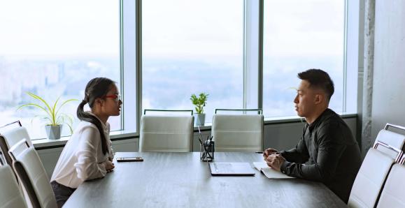 Man and woman sitting face to face across a table