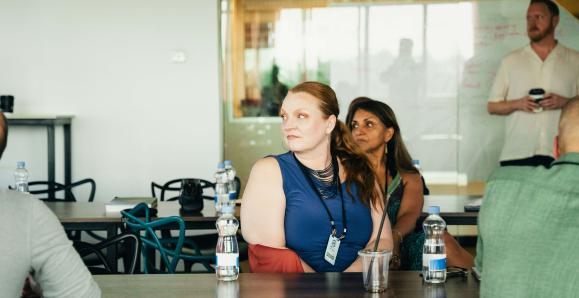 Three people at a table looking toward a presentation off screen