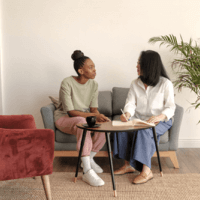 two women having a conversation at a table