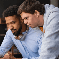 two colleagues looking at a computer together