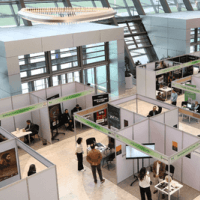 people networking and exploring booths at a career fair