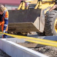 construction worker on site taking measurements