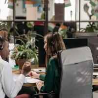 Diverse call center agents collaborating in a modern office environment