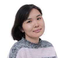 A person looking at the camera and smiling warmly in a pink striped jumper.